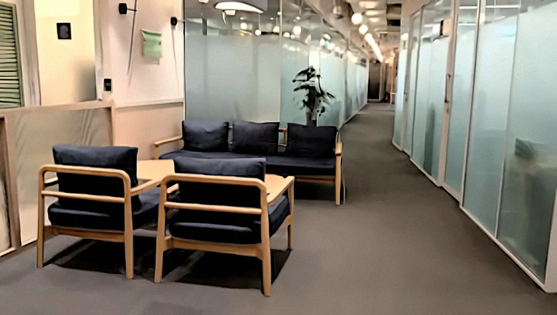 Seating area and glass-walled meeting rooms at the Procor office, New Delhi