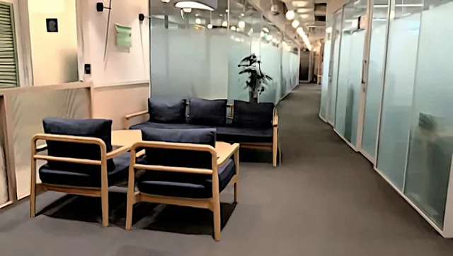 Seating area and glass-walled meeting rooms at the Procor office, New Delhi