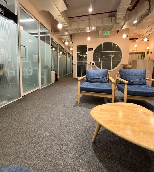Lounge seating and glass-walled meeting rooms at the Procor office